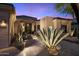 Inviting front exterior with desert landscaping and modern architectural details at twilight at 33667 N 71St Way, Scottsdale, AZ 85266