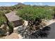 Charming home with a tile roof, desert landscaping, and mature trees in a scenic mountain setting at 33667 N 71St Way, Scottsdale, AZ 85266