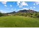 Beautiful green golf course against a backdrop of mountains and blue skies, showcasing the natural beauty of the area at 33667 N 71St Way, Scottsdale, AZ 85266