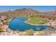 Scenic golf course view with a tranquil lake, lush greenery, and majestic mountain backdrop offering a serene escape at 33667 N 71St Way, Scottsdale, AZ 85266