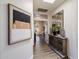 Hallway featuring a decorative mirror, wooden console table, and modern artwork at 33667 N 71St Way, Scottsdale, AZ 85266