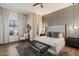 Main bedroom featuring a textured wall, stylish decor, and abundant natural light and hardwood floors at 33667 N 71St Way, Scottsdale, AZ 85266