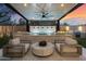 Outdoor living area featuring a water feature, built-in grill, and comfortable seating area with modern features at 33667 N 71St Way, Scottsdale, AZ 85266