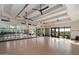 Bright workout room with hardwood floors, mirrored walls, ceiling fans and natural light showcases a healthy lifestyle at 33667 N 71St Way, Scottsdale, AZ 85266