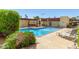 Community pool with clear water, lounge seating, shade and lush green bushes at 3828 N 32Nd St # 213, Phoenix, AZ 85018