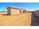 Aerial back exterior view of home and storage shed, block wall, and ready back yard at 3850 N Mateo Dr, Eloy, AZ 85131