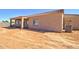 Exterior view of the back of house, highlighting a covered patio and a freshly prepped yard space at 3850 N Mateo Dr, Eloy, AZ 85131