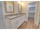Double sink bathroom with tile floors, a large mirror, and walk-in closet access at 3850 N Mateo Dr, Eloy, AZ 85131
