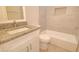This renovated bathroom features a granite vanity and white subway tiled tub and shower at 3850 N Mateo Dr, Eloy, AZ 85131
