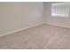 Carpeted bedroom with neutral walls and a window offering natural light at 3850 N Mateo Dr, Eloy, AZ 85131