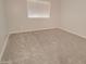 A cozy bedroom offers new carpet and a large window for plenty of natural light at 3850 N Mateo Dr, Eloy, AZ 85131