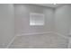 Minimalist bedroom with light tile flooring, a window, and neutral paint at 3850 N Mateo Dr, Eloy, AZ 85131