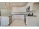 Open kitchen with white cabinets, stainless steel appliances, and granite countertops at 3850 N Mateo Dr, Eloy, AZ 85131