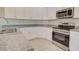 Bright kitchen featuring white cabinetry, granite countertops, and stainless steel appliances at 3850 N Mateo Dr, Eloy, AZ 85131