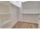 Large walk-in closet featuring custom shelving and wood-look tile floor at 3850 N Mateo Dr, Eloy, AZ 85131