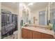 Bathroom boasts double sinks with granite countertop, decorative curtain and ample mirror space at 3855 S Mcqueen Rd # 12, Chandler, AZ 85286