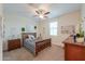 Comfortable bedroom featuring a ceiling fan, artwork, and a bed with stylish patterned bedding at 3855 S Mcqueen Rd # 12, Chandler, AZ 85286
