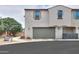 Townhome exterior featuring a garage, and landscaped surroundings at 3855 S Mcqueen Rd # 12, Chandler, AZ 85286