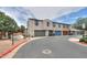 Townhome exterior showcasing multiple garages and a well-maintained street view at 3855 S Mcqueen Rd # 12, Chandler, AZ 85286