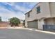 Townhome exterior showcasing a garage, stone accents, and low-maintenance landscaping at 3855 S Mcqueen Rd # 12, Chandler, AZ 85286
