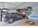 Spacious garage with an dark SUV parked inside and storage racks mounted on the back wall at 3855 S Mcqueen Rd # 12, Chandler, AZ 85286
