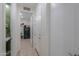 Hallway view showing the powder room, laundry room, and a closed white door at 3855 S Mcqueen Rd # 12, Chandler, AZ 85286