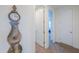 Hallway featuring an ornate clock and two doorways offering depth and architectural interest at 3855 S Mcqueen Rd # 12, Chandler, AZ 85286