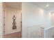 Hallway with neutral-colored walls, a grandfather clock, and a glimpse into a well-lit room at 3855 S Mcqueen Rd # 12, Chandler, AZ 85286