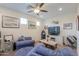 Comfortable loft area featuring cozy seating, a modern ceiling fan, and an entertainment center at 3855 S Mcqueen Rd # 12, Chandler, AZ 85286
