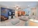 Cozy living room featuring a comfortable sofa, TV, and views into the adjacent kitchen and dining area at 3855 S Mcqueen Rd # 12, Chandler, AZ 85286