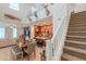 Bright, open floor plan featuring a dining area, kitchen with an island, and a staircase with white railings at 3855 S Mcqueen Rd # 12, Chandler, AZ 85286