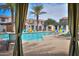 Relaxing view of the community pool, with lounge chairs and lush landscaping at 3855 S Mcqueen Rd # 12, Chandler, AZ 85286