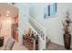 Inviting entryway showcasing a staircase with white railings, complemented by a rustic wooden bar area at 3855 S Mcqueen Rd # 12, Chandler, AZ 85286