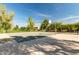 Outdoor basketball court, with a clean playing surface, surrounded by trees and landscaping at 3875 E Claxton Ave, Gilbert, AZ 85297