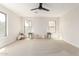 Bright bedroom with plush carpet, a modern ceiling fan, and large windows that bring in natural light at 3875 E Claxton Ave, Gilbert, AZ 85297