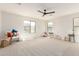 Spacious bedroom featuring plush carpeting, a ceiling fan, and large windows offering ample natural light at 3875 E Claxton Ave, Gilbert, AZ 85297