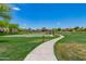 A view of the community park showcasing the volleyball court, basketball court and a walking path on a sunny day at 3875 E Claxton Ave, Gilbert, AZ 85297