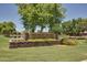 Community sign reading 'Ranch House Clubhouse & Park' near a pond on a sunny day at 3875 E Claxton Ave, Gilbert, AZ 85297