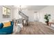 Inviting dining space with wood-look floors, modern lighting, and staircase access at 3875 E Claxton Ave, Gilbert, AZ 85297