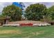 Landscaped community entrance sign with colorful flowers and a signature windmill at 3875 E Claxton Ave, Gilbert, AZ 85297