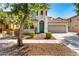Charming two-story home with a well-manicured yard, neutral stucco, and a two-car garage at 3875 E Claxton Ave, Gilbert, AZ 85297