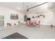 Spacious garage featuring an epoxy floor, retro decor, and a full table and chairs at 3875 E Claxton Ave, Gilbert, AZ 85297
