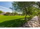 Beautiful grassy field with walking path, trees, and landscaping in a quiet neighborhood at 3875 E Claxton Ave, Gilbert, AZ 85297