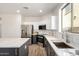 Bright kitchen with stainless steel appliances, stylish countertops, a kitchen island, and wood-look flooring at 3875 E Claxton Ave, Gilbert, AZ 85297