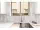 A close-up of a kitchen sink and faucet, showcasing bright countertops, white subway tile, and ample natural light at 3875 E Claxton Ave, Gilbert, AZ 85297