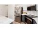 This kitchen has stainless steel refrigerator, sleek appliances, and stylish dark gray cabinets at 3875 E Claxton Ave, Gilbert, AZ 85297