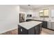 Modern kitchen boasts stainless steel appliances, white and gray cabinetry, and a spacious center island at 3875 E Claxton Ave, Gilbert, AZ 85297