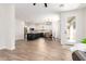 Open-concept kitchen and living area with modern appliances and flooring at 3875 E Claxton Ave, Gilbert, AZ 85297
