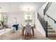 Open concept living space with dining area and staircase at 3875 E Claxton Ave, Gilbert, AZ 85297