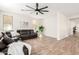 Spacious living room with a large leather sectional, wood-look floors, and neutral walls at 3875 E Claxton Ave, Gilbert, AZ 85297